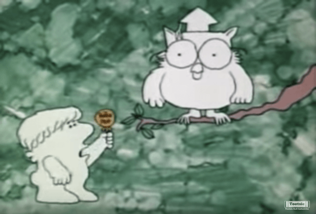A freeze frame from the classic Tootsie Pop commercial with the owl and a young boy. 